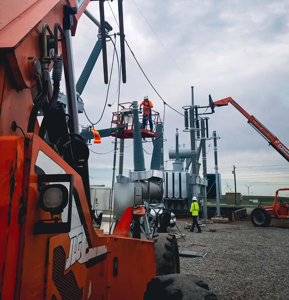 Worker on a elevated platform at a substation