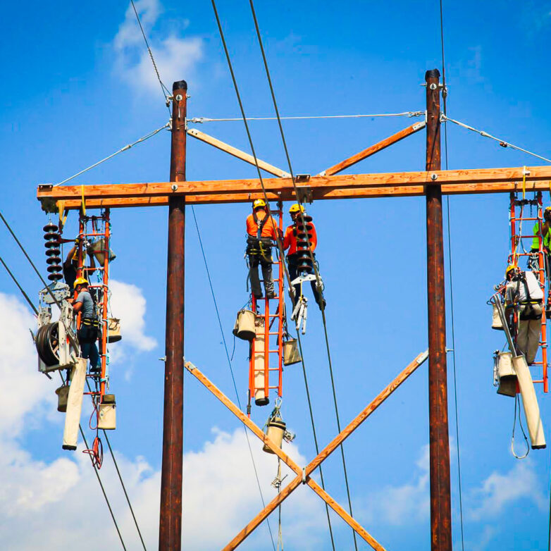 Six MYR Group employees elevated in the sky to work on transmission lines