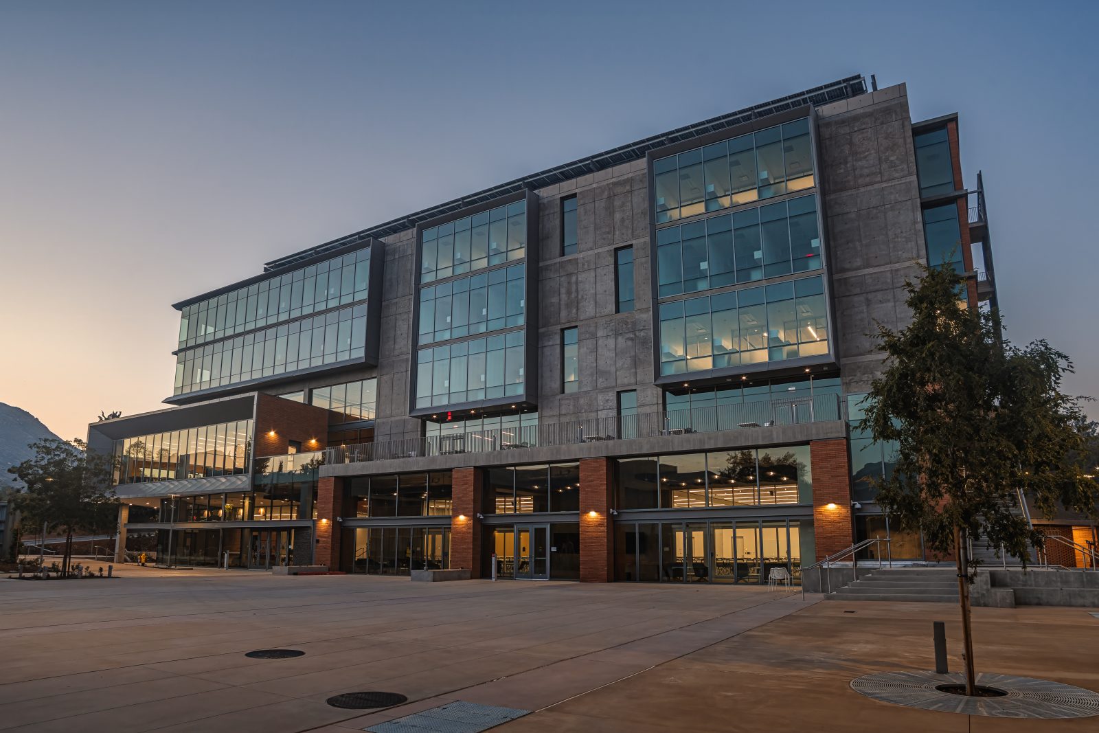 a large building with many windows lit at dusk
