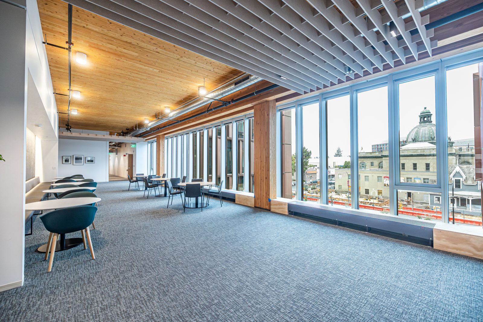 a seating area inside a building with wall to wall windows